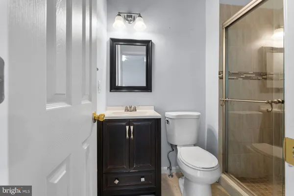 a bathroom with a toilet sink and shower