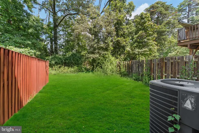 a view of backyard with seating and green space