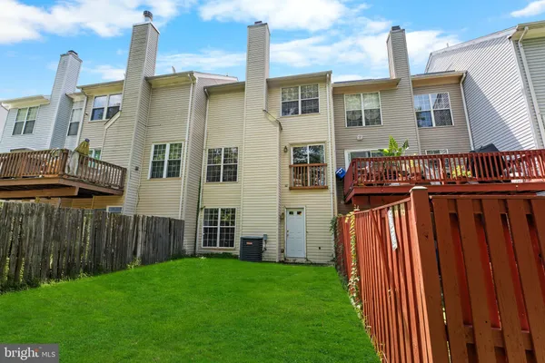 a view of a house with backyard and deck