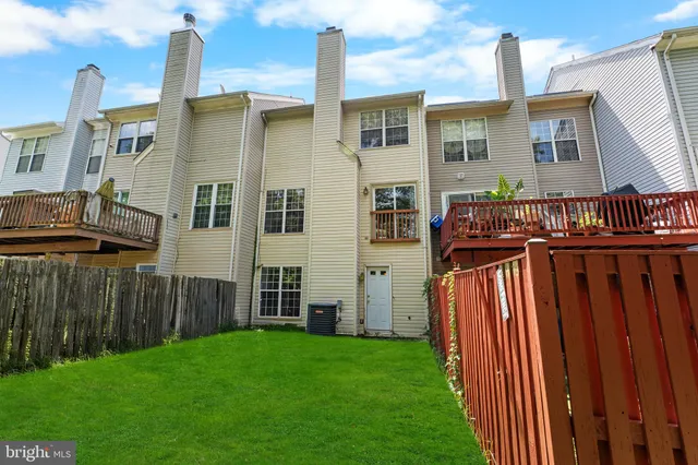 a view of a house with backyard and deck