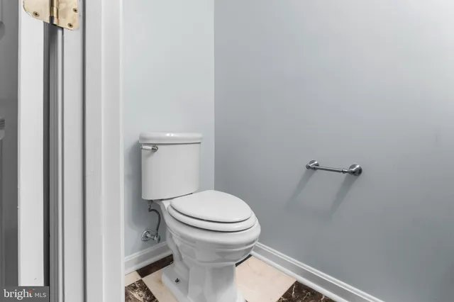 a white toilet sitting next to a shower
