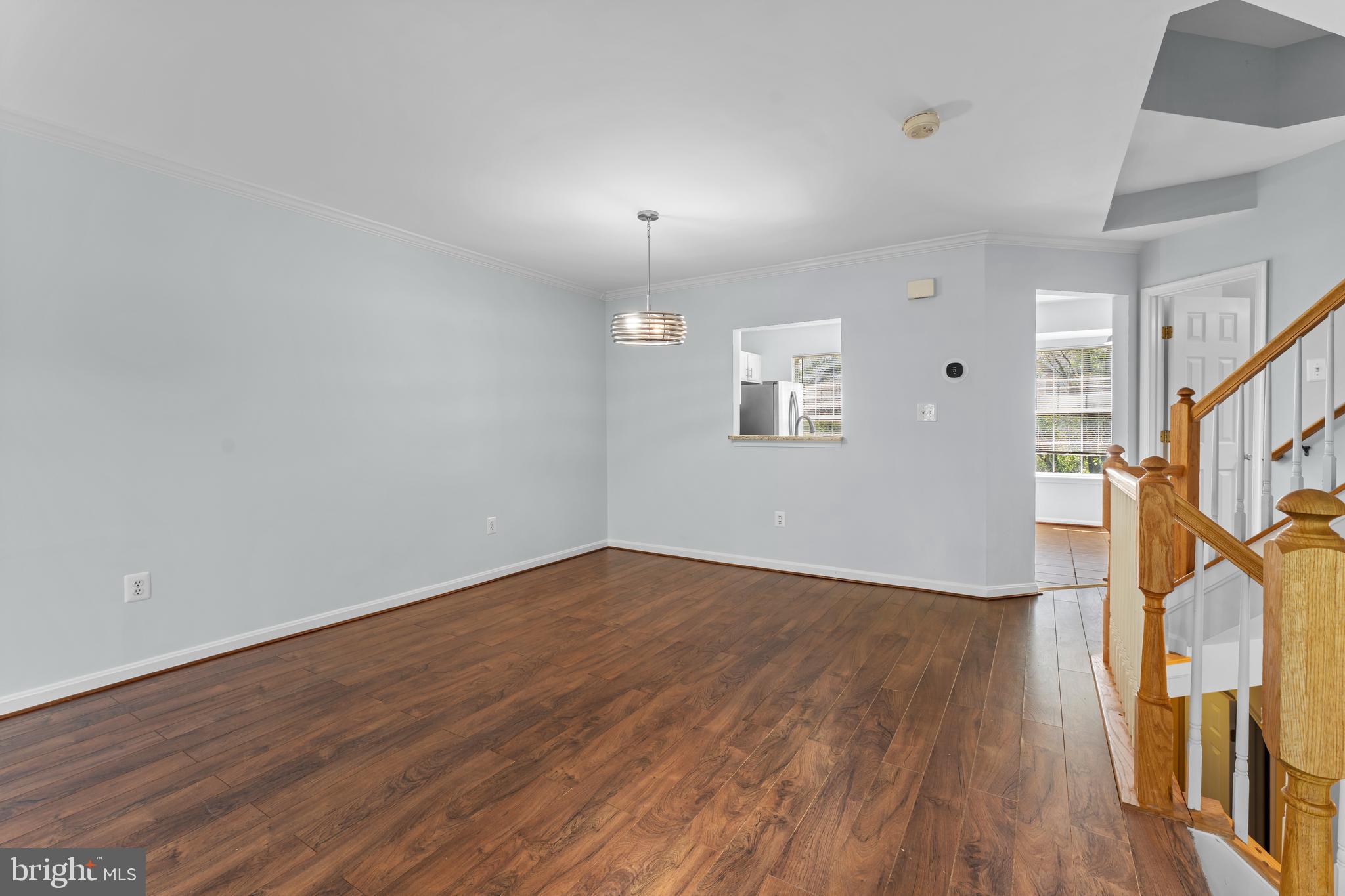 2204 Commissary Circle Odenton, MD 21113 - Photo 10 of 32 a view of an empty room with wooden floor and a window