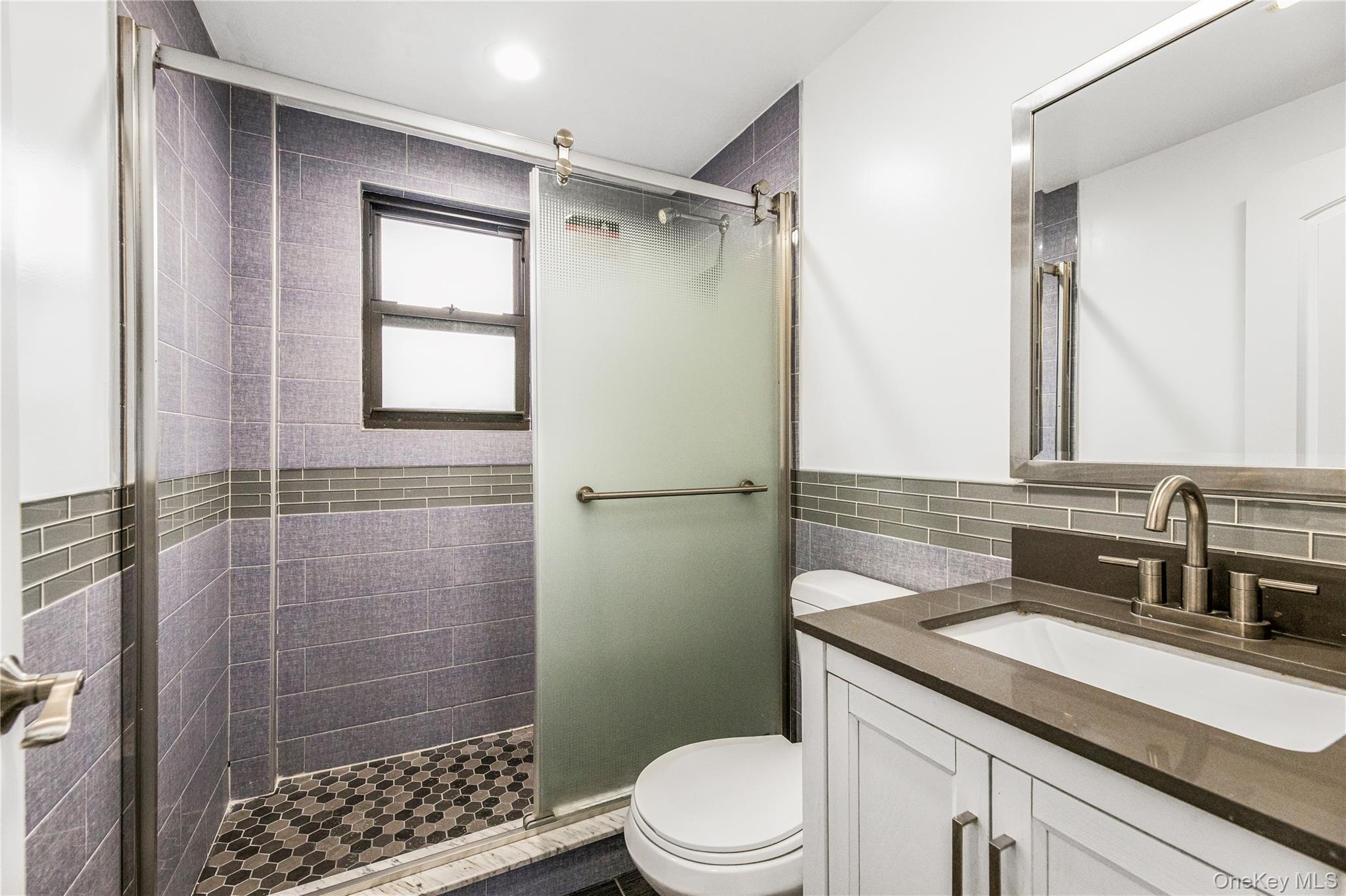 3067 Williamsbridge Road Bronx, NY 10467 - Photo 23 of 29 a bathroom with a sink a toilet and shower