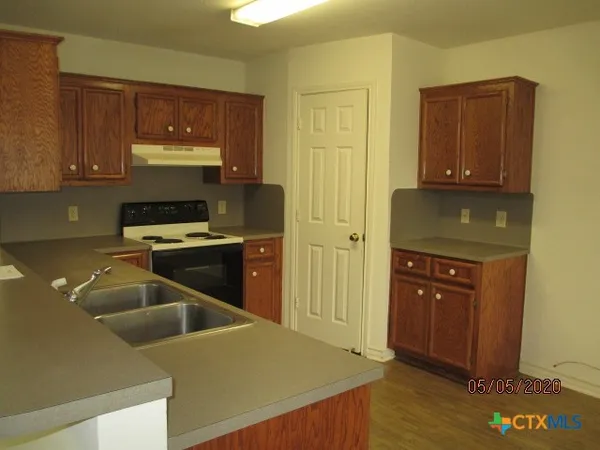 a kitchen with a cabinets and wooden floor