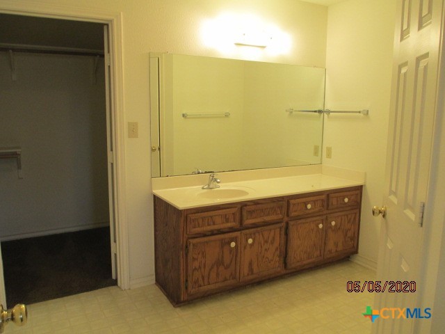103 Evan Circle Victoria, TX 77901 - Photo 17 of 22 a bathroom with a granite countertop sink and a mirror
