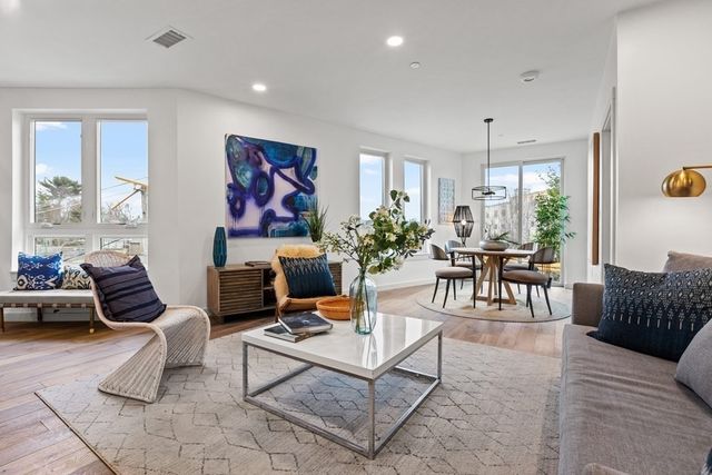 a living room with furniture a rug and a chandelier