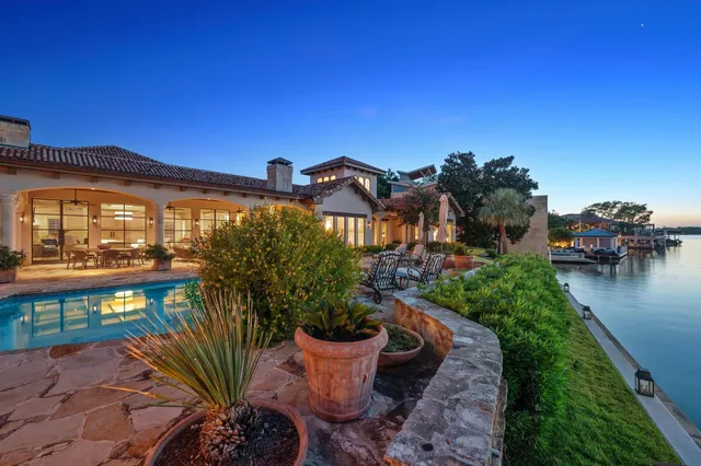 a view of a patio with couches table and chairs and potted plants