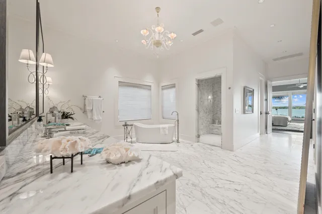 a living room with furniture a chandelier and a dining room