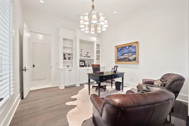 a large bedroom with a bed and large windows