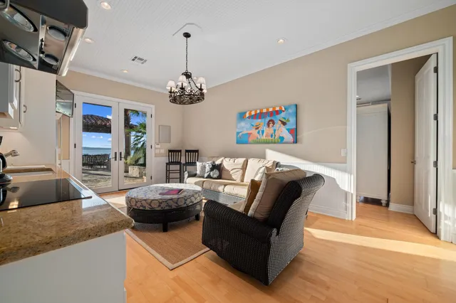 a spacious bedroom with a large bed and a chandelier