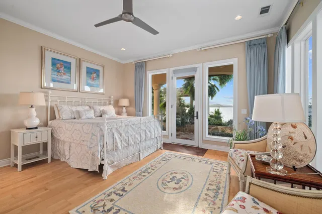 a spacious bedroom with a large bed and a chandelier