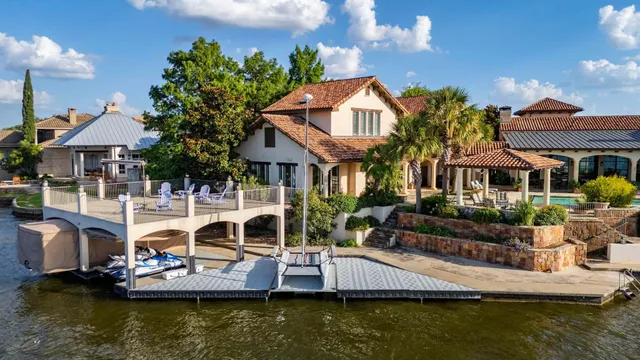 a front view of a house with a garden and swimming pool