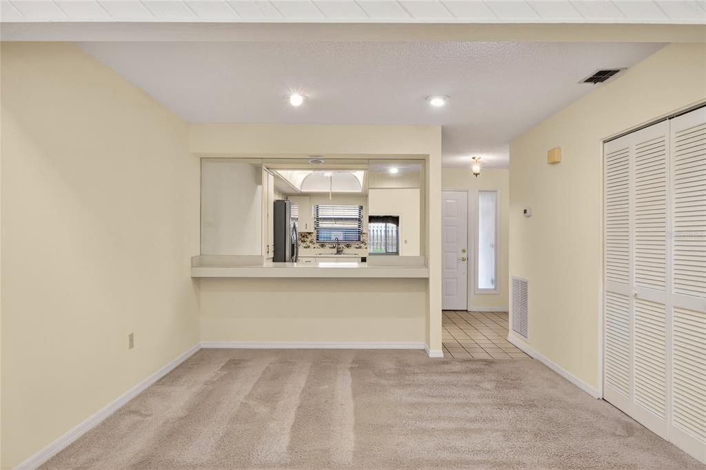 2025 Sylvester Road, Unit H3 Lakeland, FL 33803 - Photo 13 of 49 a view of open kitchen with kitchen island a sink wooden floor and a refrigerator