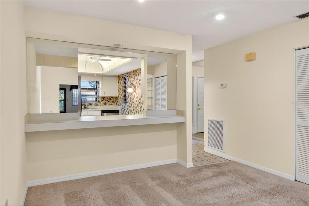 2025 Sylvester Road, Unit H3 Lakeland, FL 33803 - Photo 14 of 49 a living room with kitchen island granite countertop furniture and a mirror