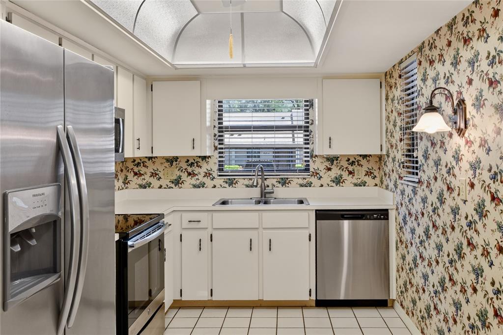 2025 Sylvester Road, Unit H3 Lakeland, FL 33803 - Photo 15 of 49 a kitchen with granite countertop white cabinets and stainless steel appliances