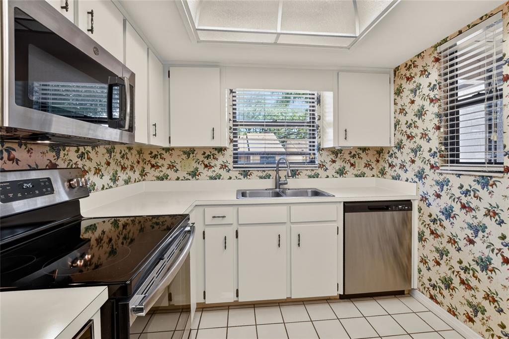 2025 Sylvester Road, Unit H3 Lakeland, FL 33803 - Photo 17 of 49 a kitchen with a sink stove and cabinets