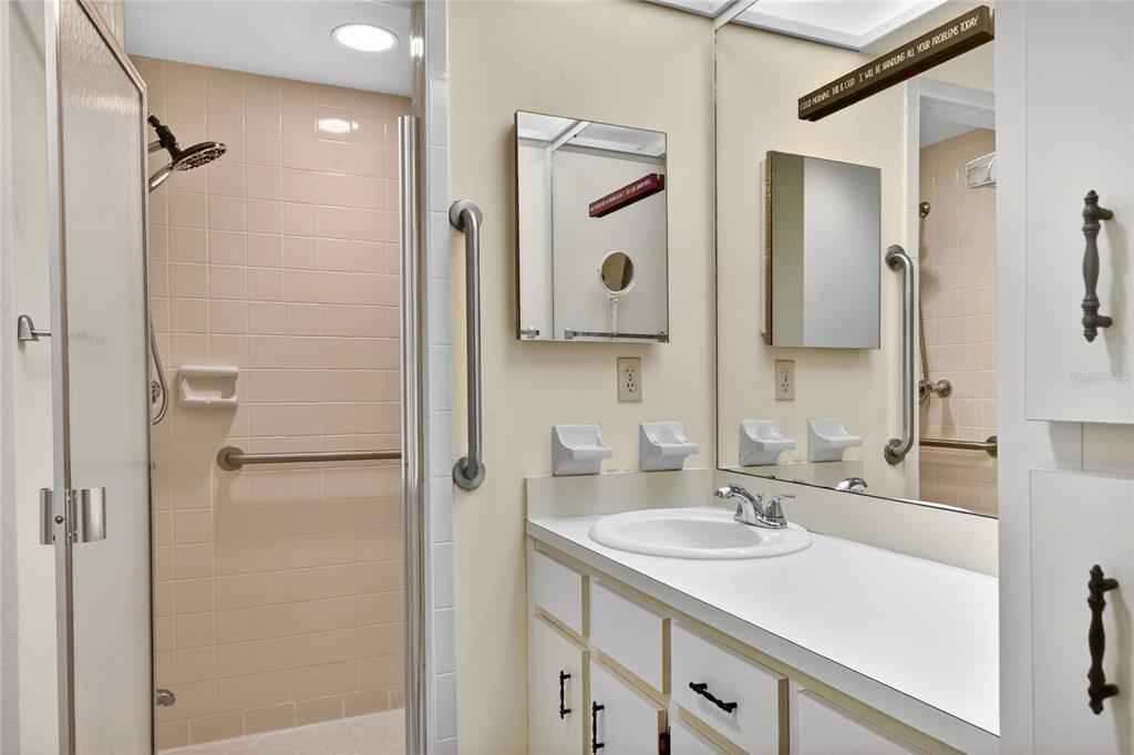 2025 Sylvester Road, Unit H3 Lakeland, FL 33803 - Photo 24 of 49 a bathroom with a sink vanity granite shower and a mirror