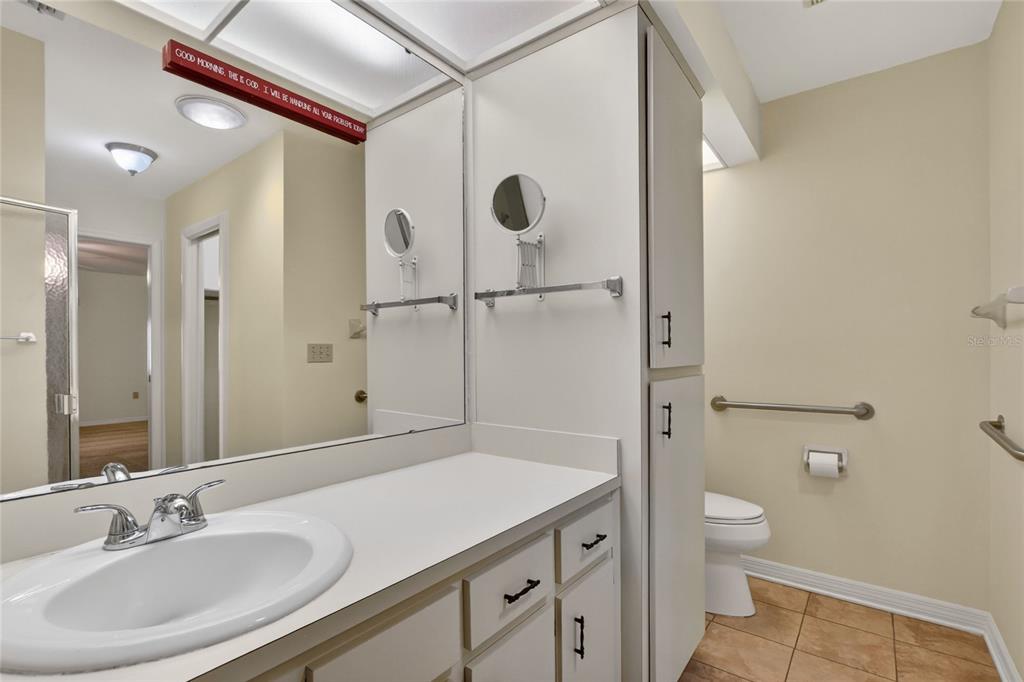 2025 Sylvester Road, Unit H3 Lakeland, FL 33803 - Photo 25 of 49 a bathroom with a granite countertop sink a toilet and shower