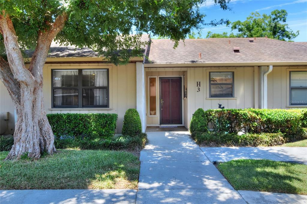 2025 Sylvester Road, Unit H3 Lakeland, FL 33803 - Photo 3 of 49 a front view of a house with a yard and potted plants