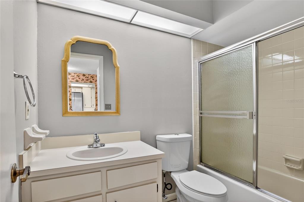2025 Sylvester Road, Unit H3 Lakeland, FL 33803 - Photo 34 of 49 a bathroom with a toilet a sink and mirror