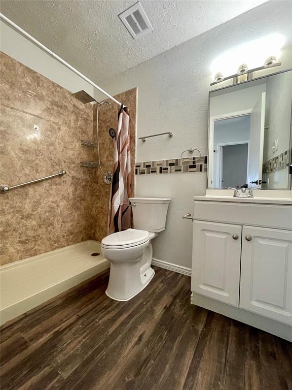 3543 Terrell Street Dallas, TX 75223 - Photo 19 of 26 a bathroom with a sink toilet and shower