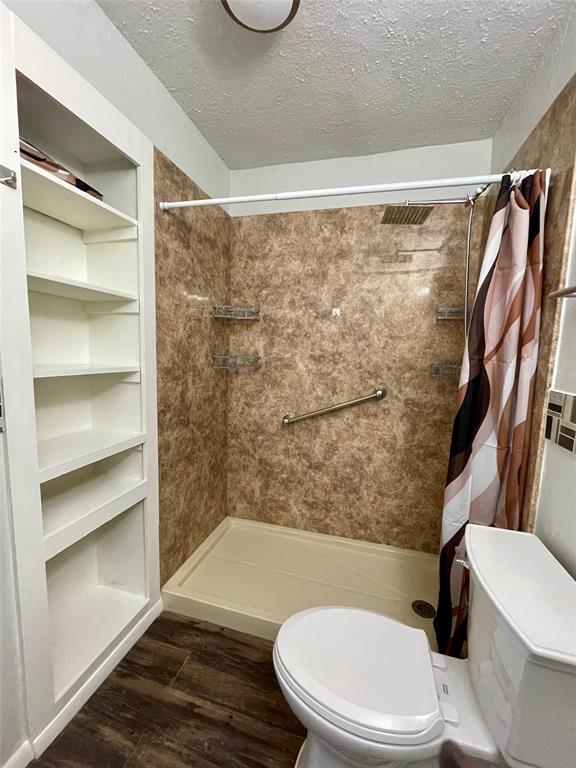 3543 Terrell Street Dallas, TX 75223 - Photo 20 of 26 a bathroom with a toilet and a shower