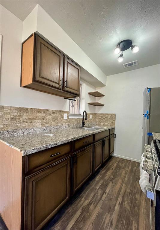 3543 Terrell Street Dallas, TX 75223 - Photo 8 of 26 a kitchen with stainless steel appliances granite countertop a sink and stove top oven
