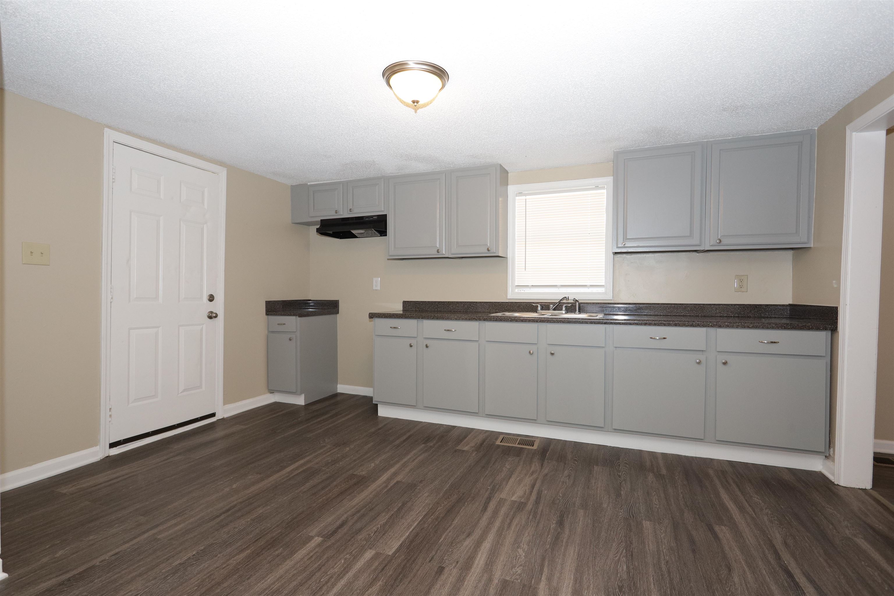 1825 Fields Road Memphis, TN 38109 - Photo 3 of 10 a kitchen with granite countertop a sink cabinets and stainless steel appliances