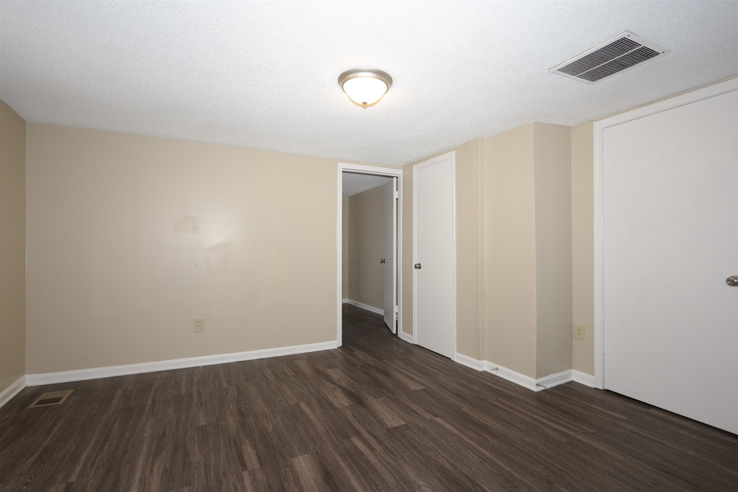 1825 Fields Road Memphis, TN 38109 - Photo 4 of 10 a view of an empty room with wooden floor