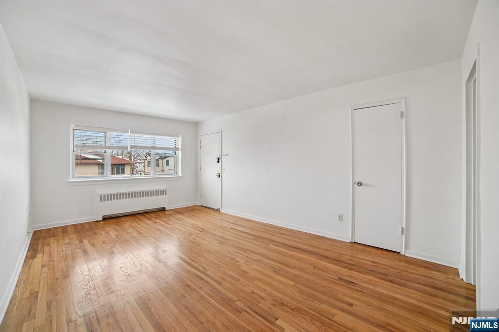 2430 8th Street, Unit 5B Fort Lee, NJ 07024 - Photo 1 of 20 an empty room with wooden floor and windows