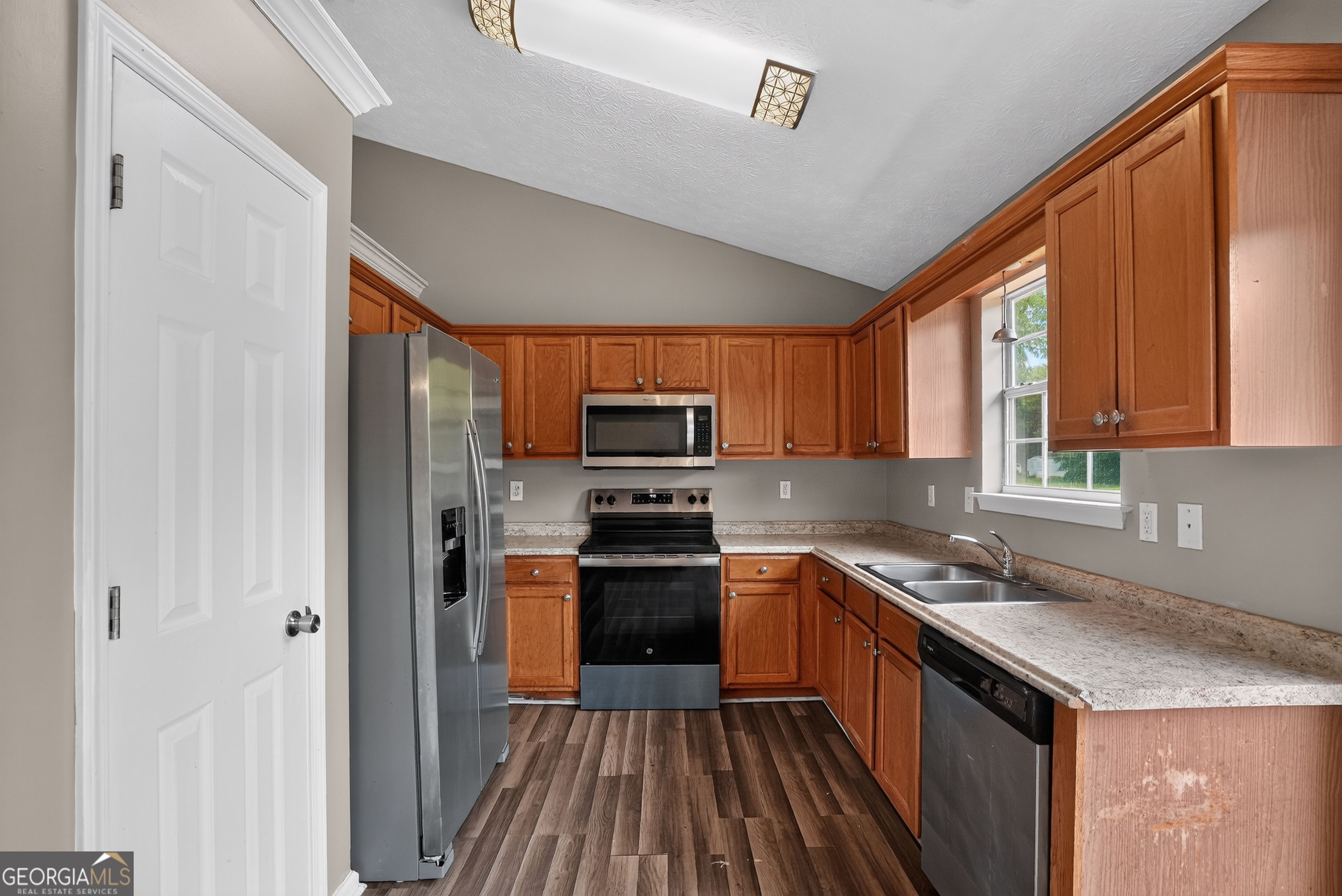 75 Linsley Way Covington, GA 30016 - Photo 26 of 48 a kitchen with stainless steel appliances granite countertop a refrigerator and a sink