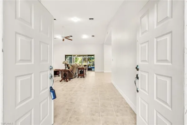 view of hall way with furniture and floor to ceiling window