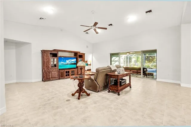 a view of a livingroom with workspace and a window