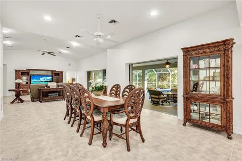 a living room with patio furniture and a fireplace