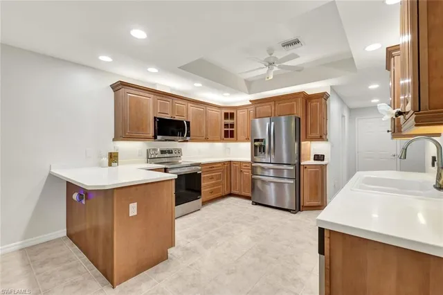 a kitchen with a sink refrigerator and microwave
