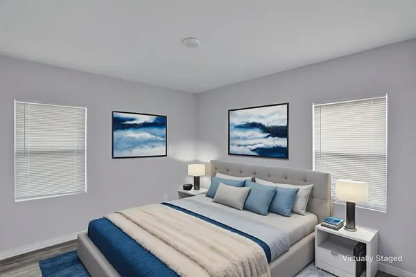 a bedroom with a bed and a painting on the wall
