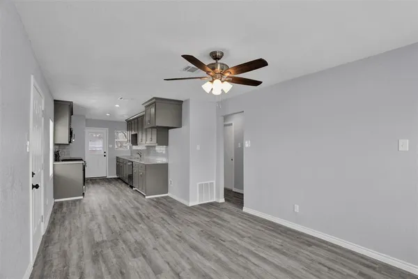 a view of a kitchen with a sink and a refrigerator