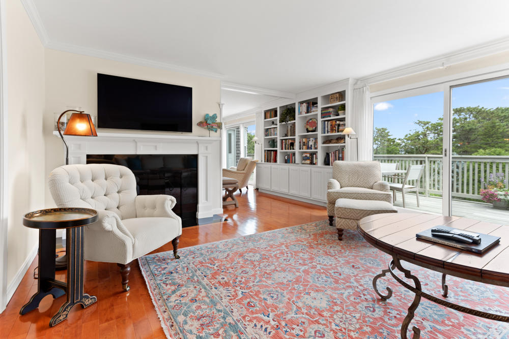 42 Gosnold Road Orleans, MA 02653 - Photo 11 of 42 a living room with furniture a fireplace and a flat screen tv