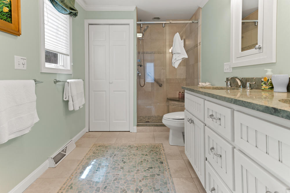 42 Gosnold Road Orleans, MA 02653 - Photo 16 of 42 a bathroom with a granite countertop sink toilet and shower