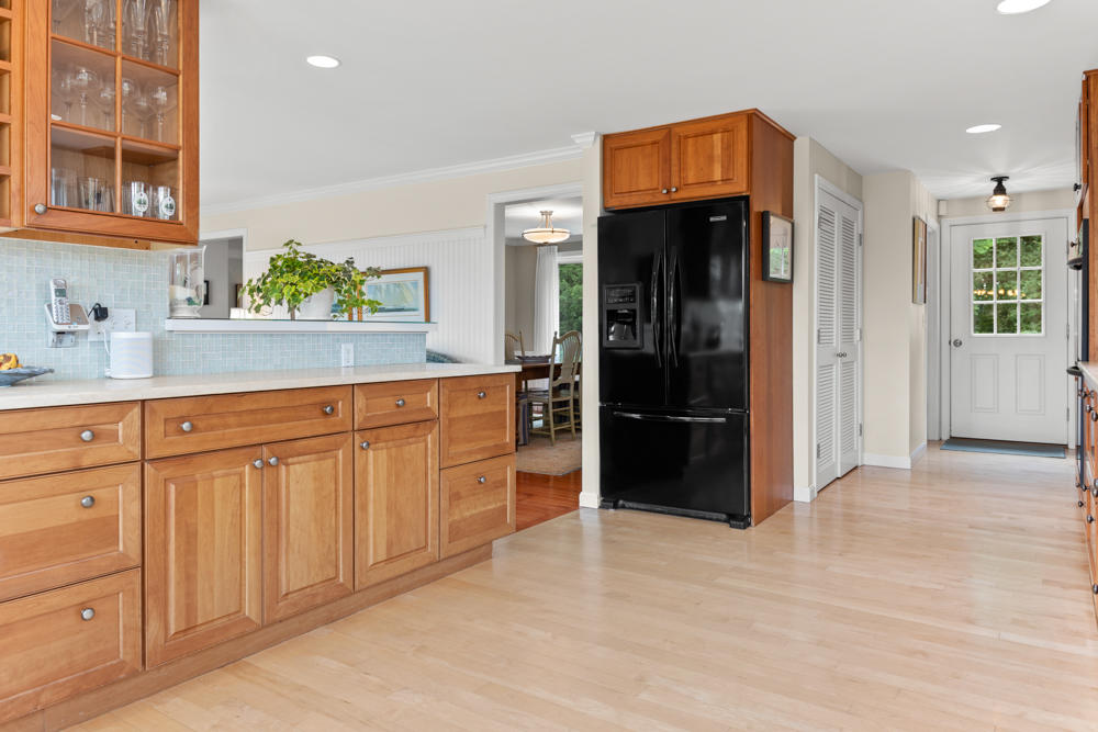 42 Gosnold Road Orleans, MA 02653 - Photo 18 of 42 a kitchen with white cabinets and refrigerator
