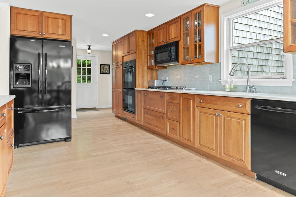 42 Gosnold Road Orleans, MA 02653 - Photo 19 of 42 a kitchen with stainless steel appliances granite countertop a refrigerator and a sink