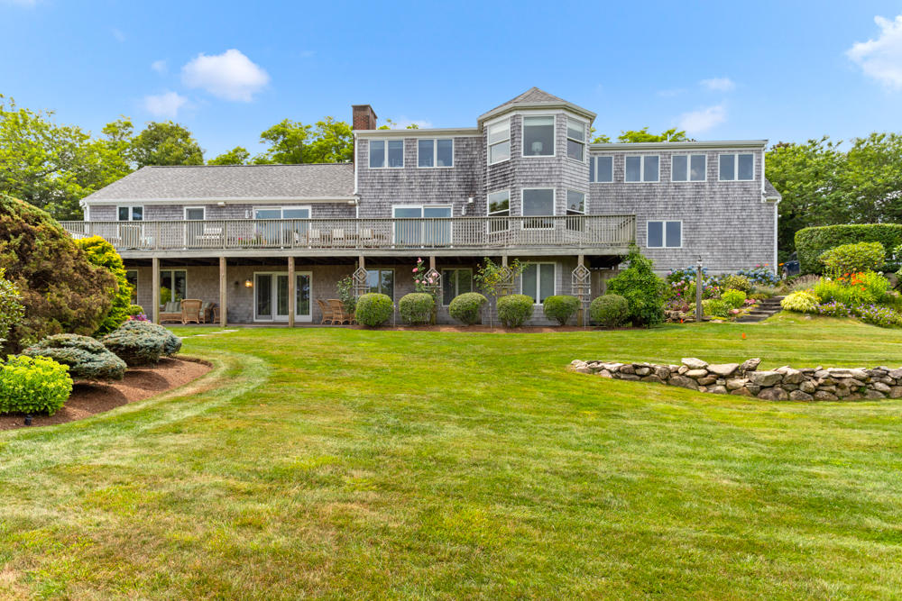 42 Gosnold Road Orleans, MA 02653 - Photo 2 of 42 a front view of a house with a garden and lake view