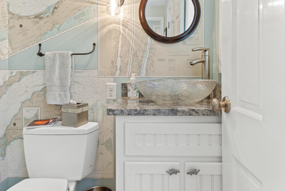42 Gosnold Road Orleans, MA 02653 - Photo 21 of 42 a bathroom with a granite countertop toilet sink and mirror