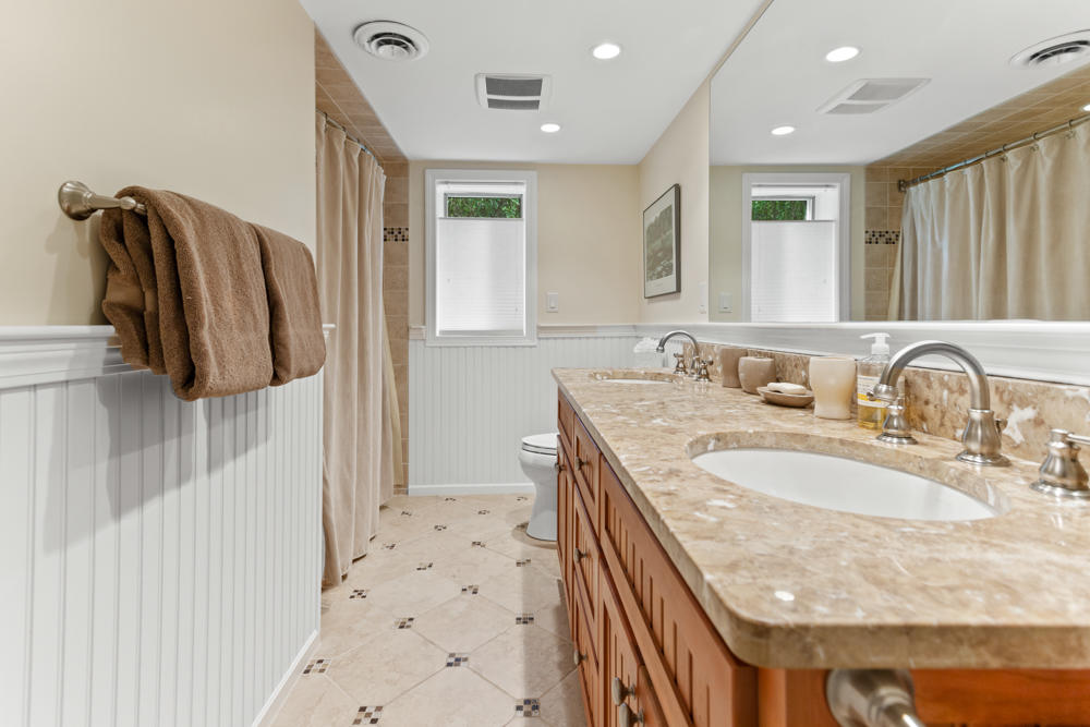 42 Gosnold Road Orleans, MA 02653 - Photo 33 of 42 a en suite bathroom with a granite countertop sink and a mirror