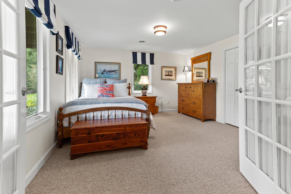 42 Gosnold Road Orleans, MA 02653 - Photo 34 of 42 a bedroom with furniture a window and a walk in closet