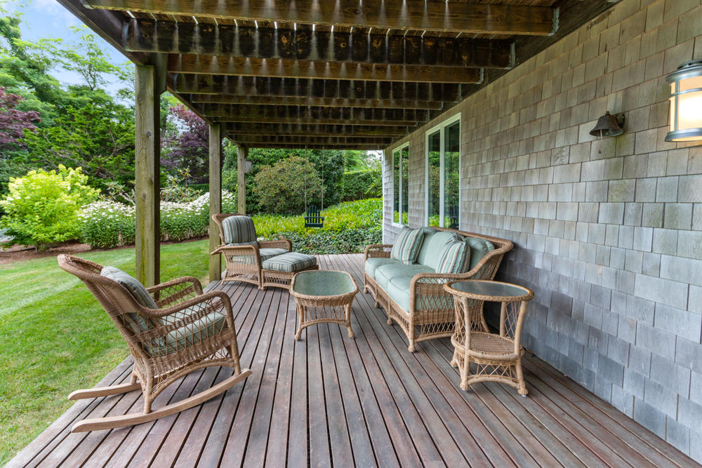 42 Gosnold Road Orleans, MA 02653 - Photo 40 of 42 a view of a roof deck with table and chairs and wooden floor