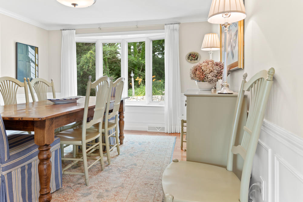 42 Gosnold Road Orleans, MA 02653 - Photo 10 of 42 a dining room with furniture a chandelier and wooden floor