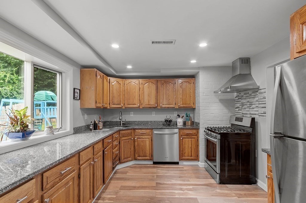 24 Algonquin Road Chelmsford, MA 01824 - Photo 1 of 38 a kitchen with stainless steel appliances granite countertop a sink a stove and a refrigerator