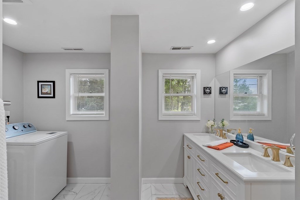 24 Algonquin Road Chelmsford, MA 01824 - Photo 19 of 38 a bathroom with a window sink and mirror