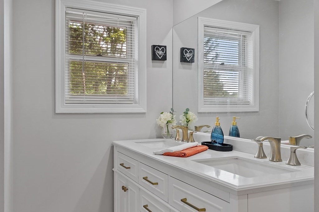 24 Algonquin Road Chelmsford, MA 01824 - Photo 20 of 38 a bathroom with a granite countertop sink and a window